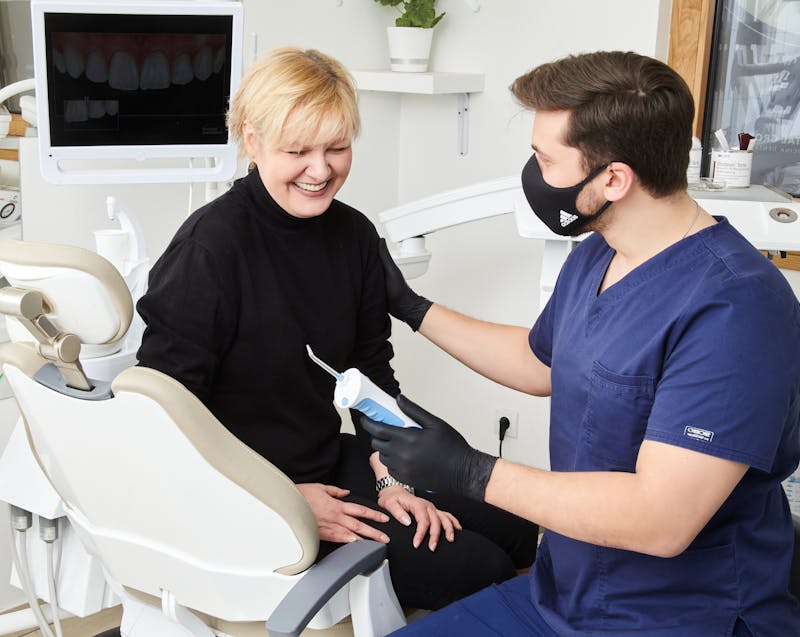 a dentist and a patient talking